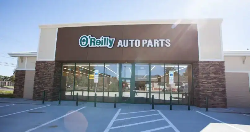 O’Reilly Auto Parts exterior with sign, glass doors, and nearby electrical contractors New Hampshire office.